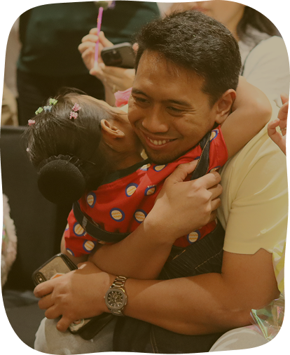 Ayah memeluk anak di kegiatan sekolah